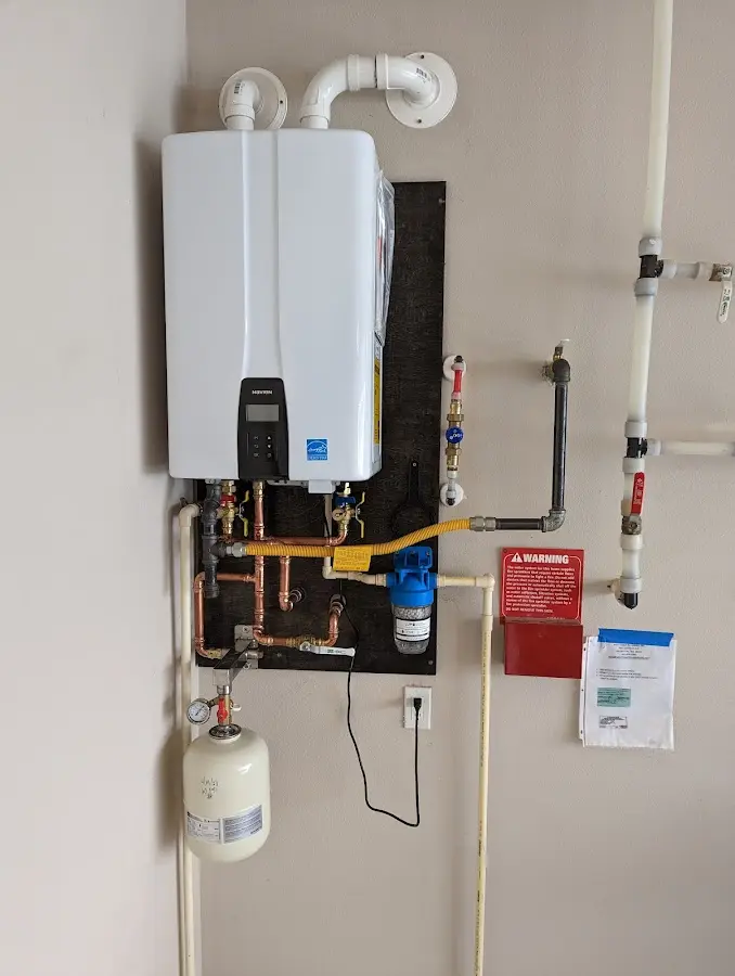 Professional plumber installing copper piping in a Independence home